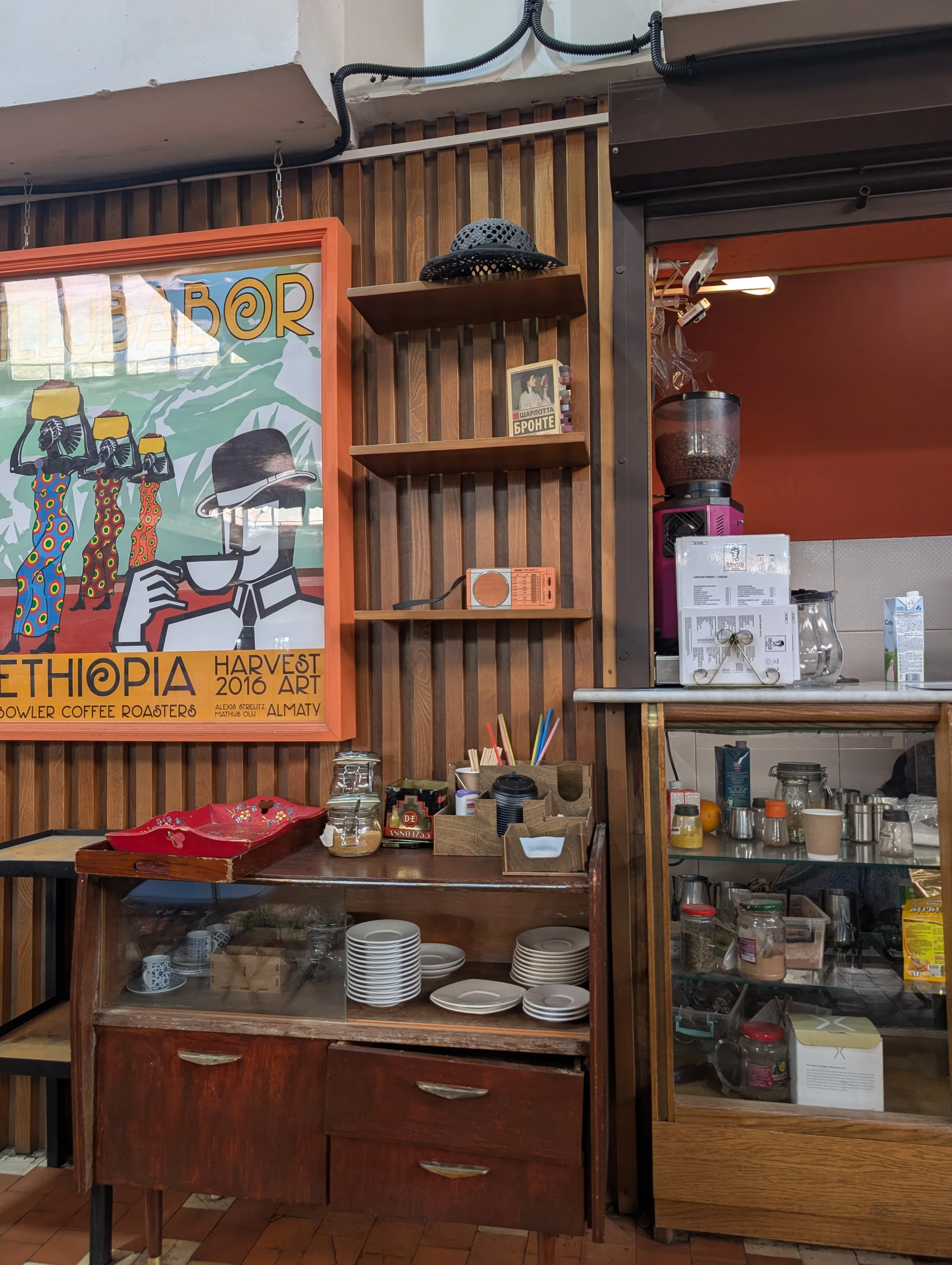 The counter at Bowler, with the Ethiopia harvest poster, a bowler hat and a vintage radio on the shelves
