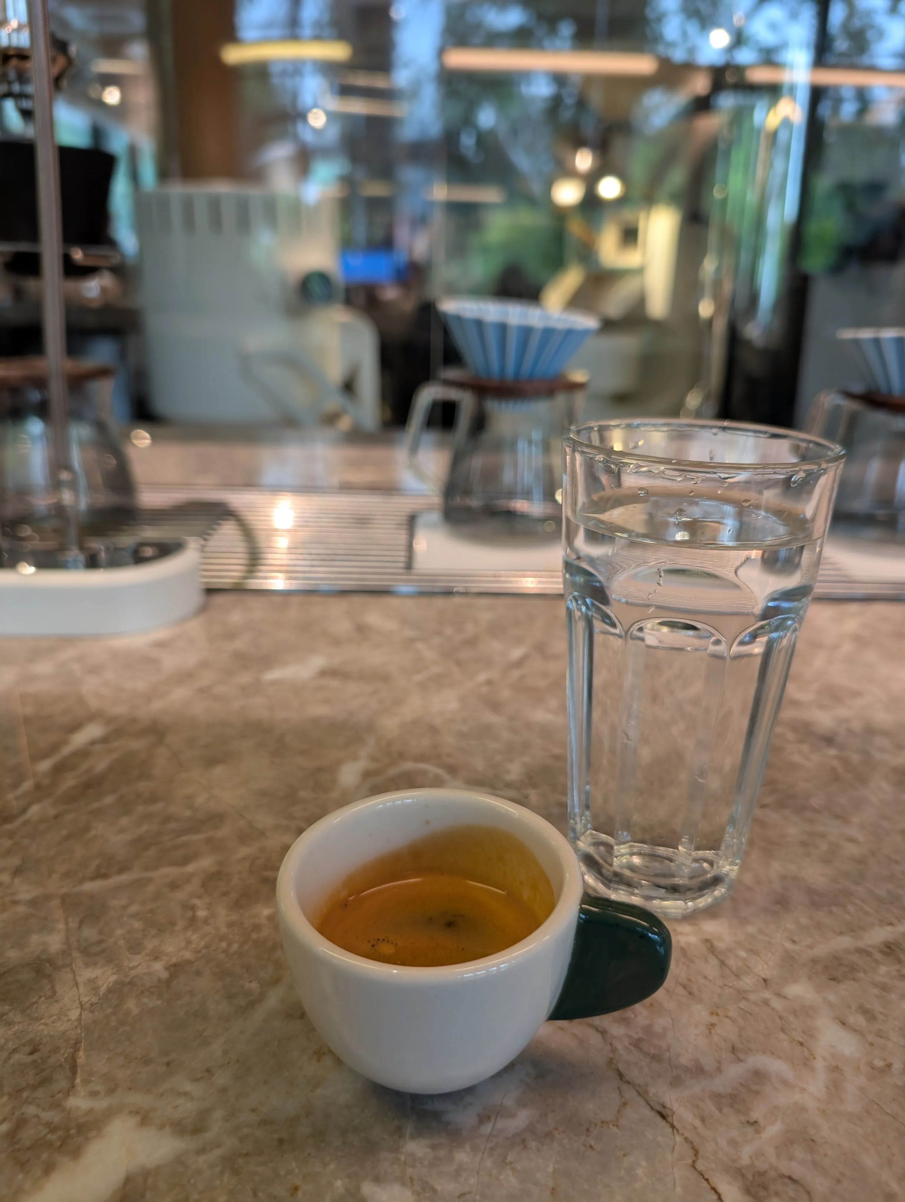 Espresso on the marble counter at Akku, with V60 drippers behind