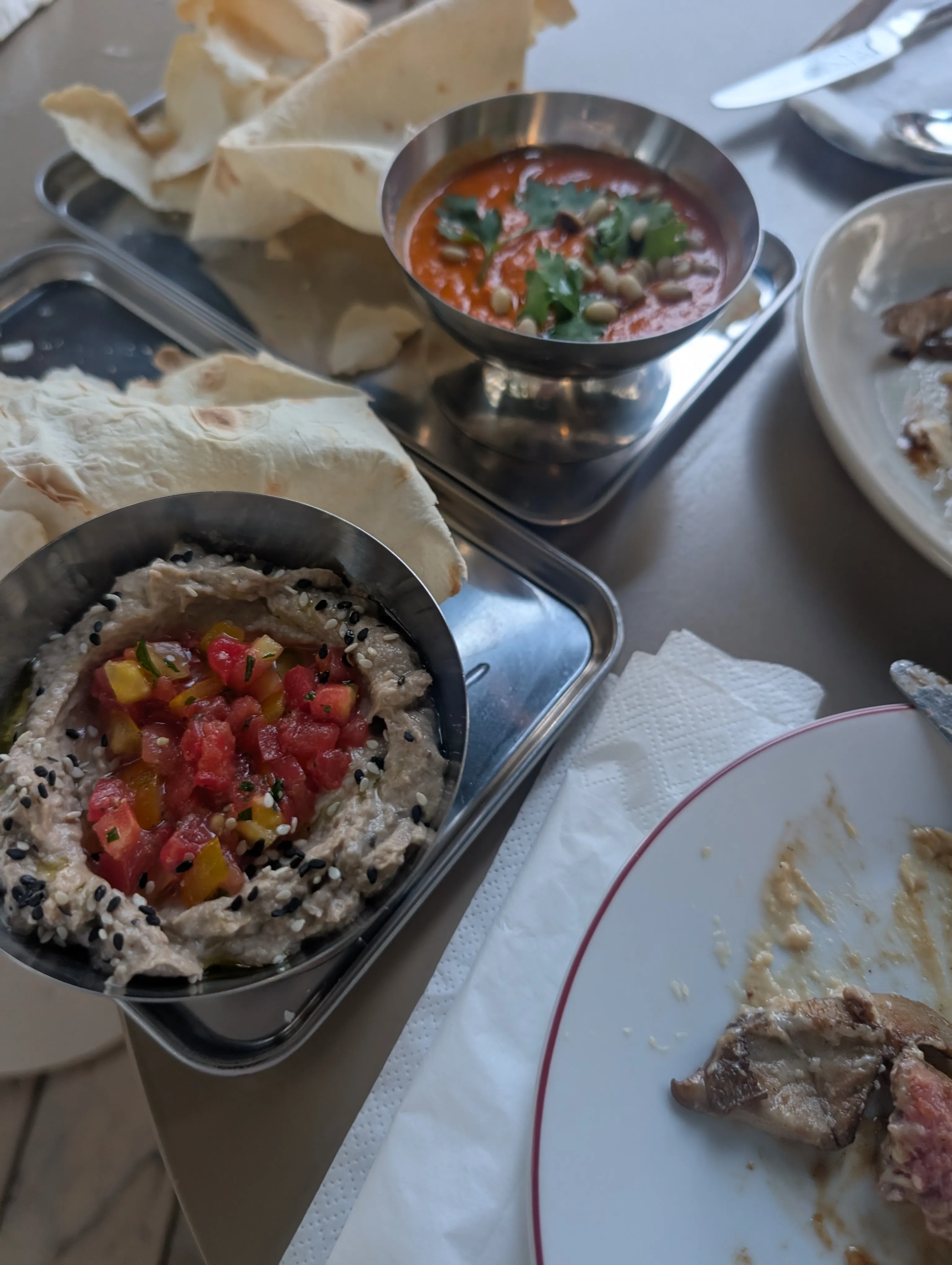 Aubergine meze with tomato salsa and sesame, a red pepper dip and lavash at Collab
