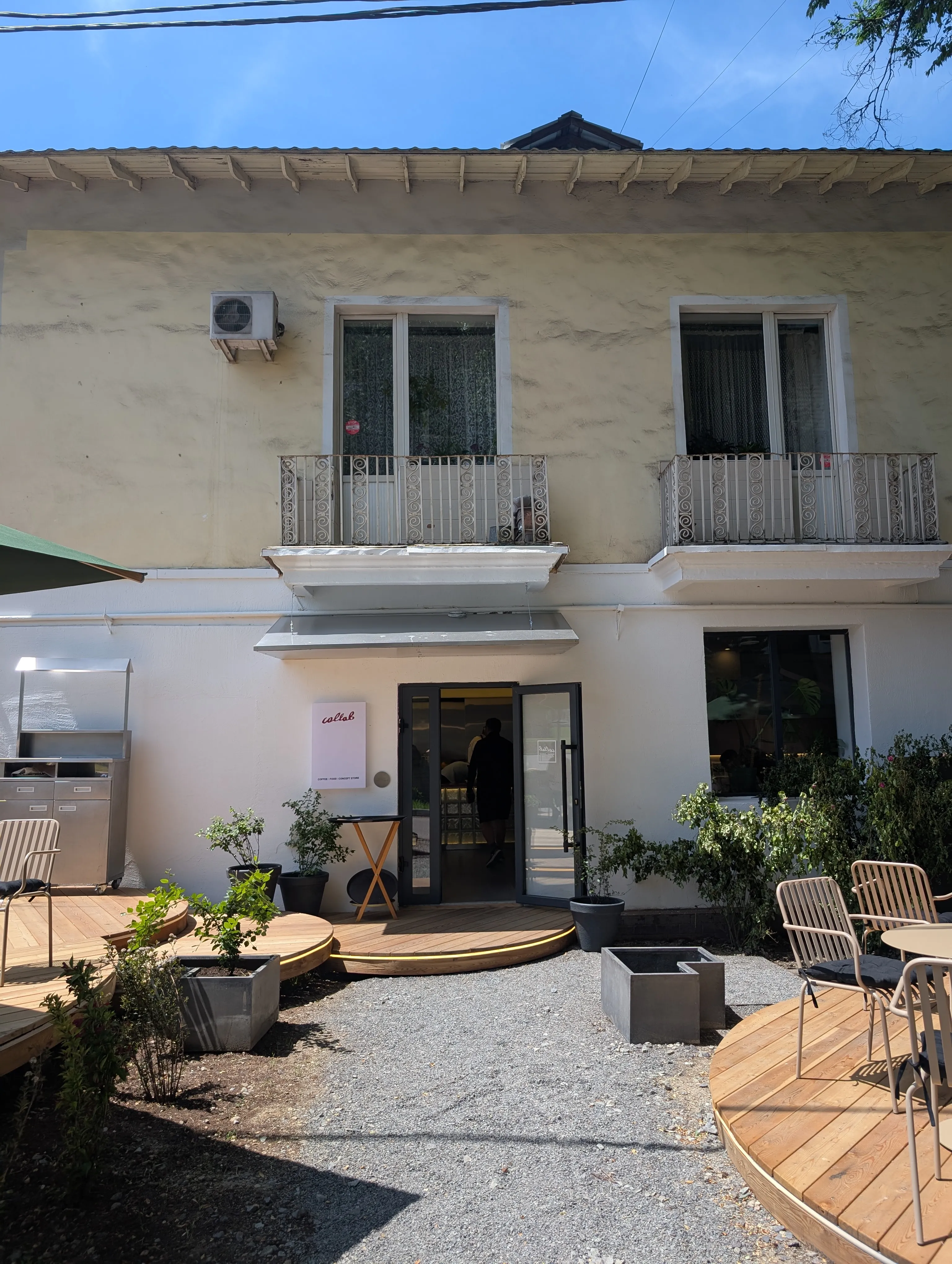 Collab from the courtyard, with the coffee, food and concept store sign by the door