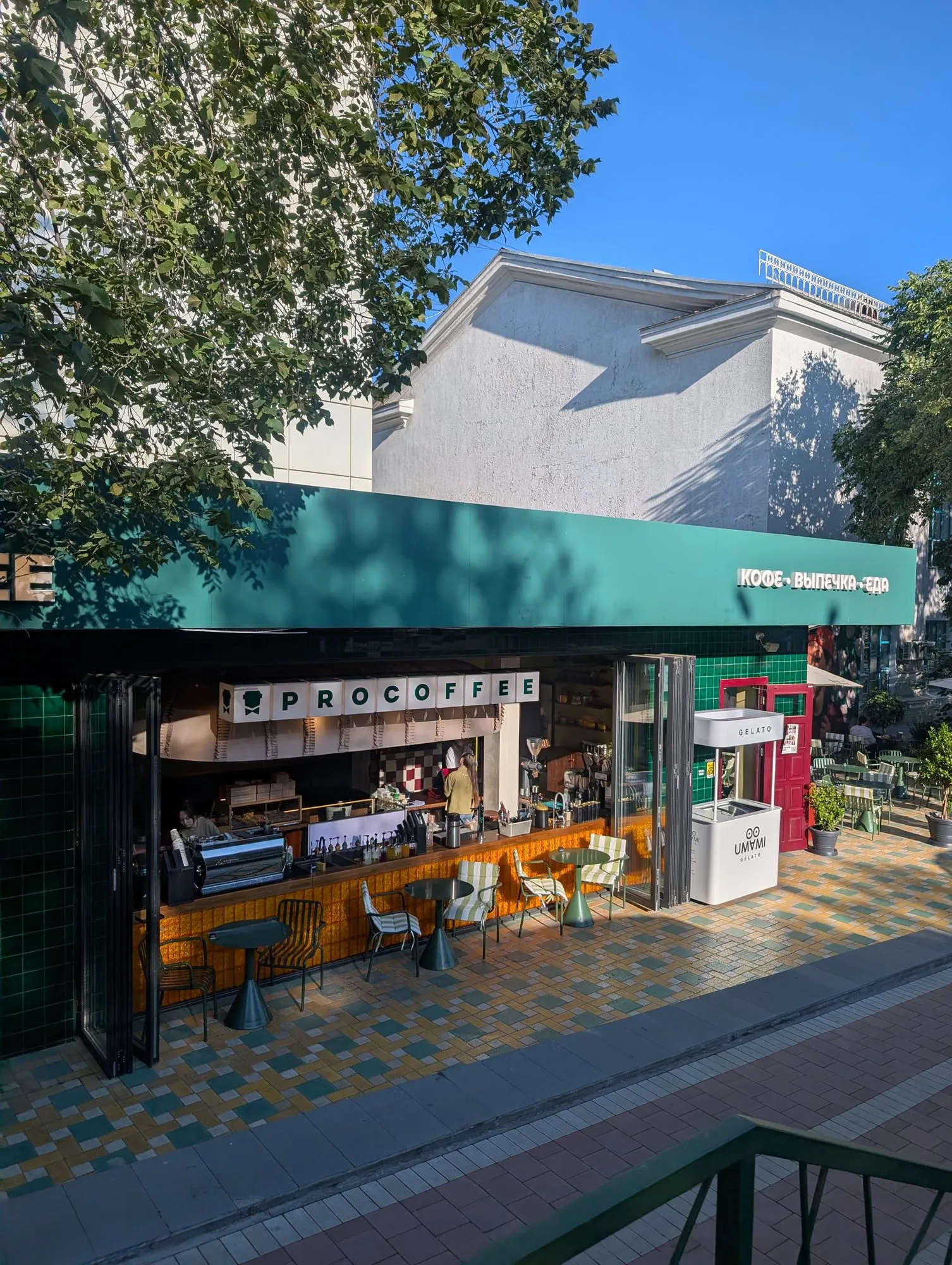 Street counter and green awning at ProCoffee on Dostyk