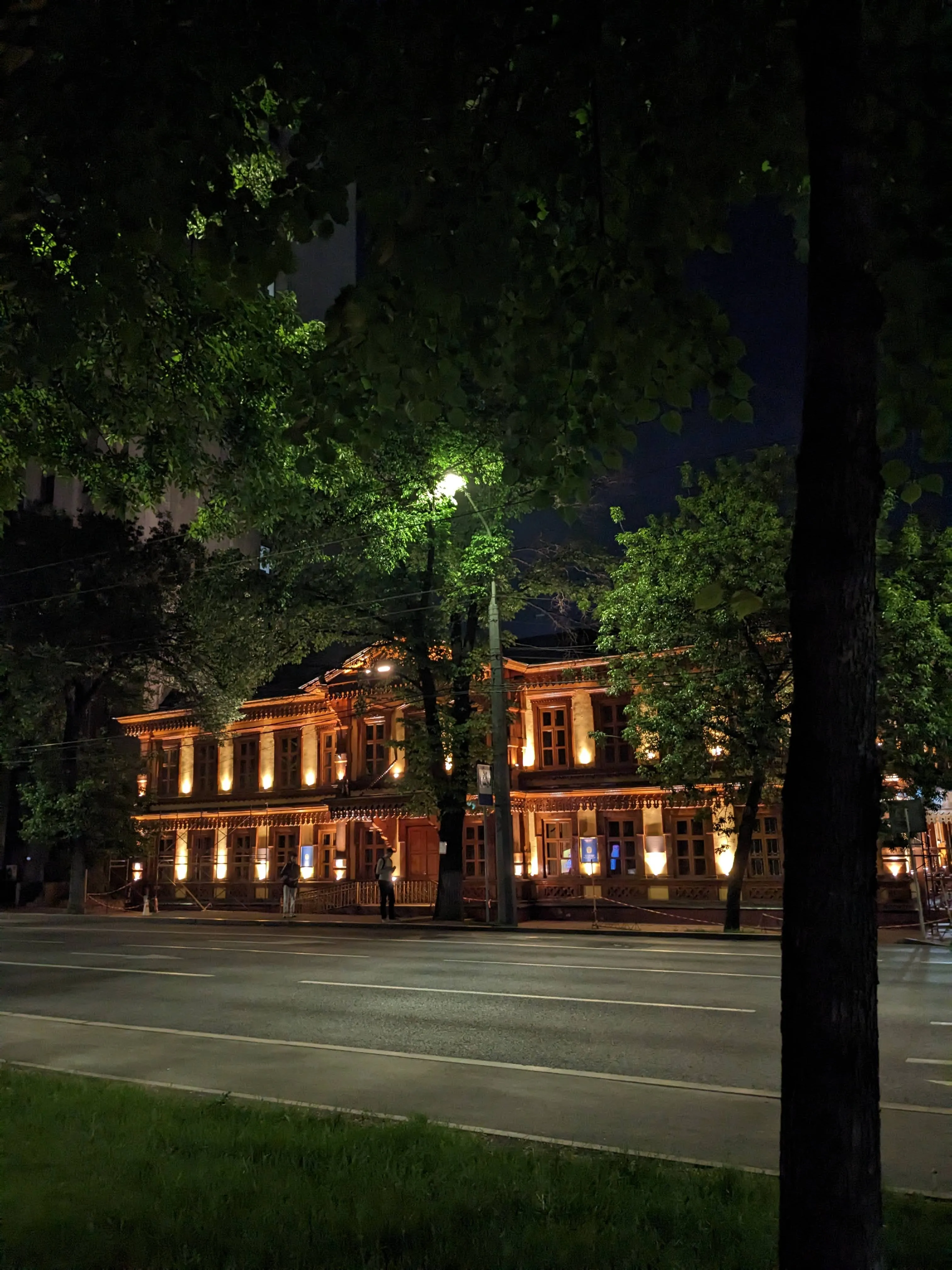 The Real School of 1890 lit at night
