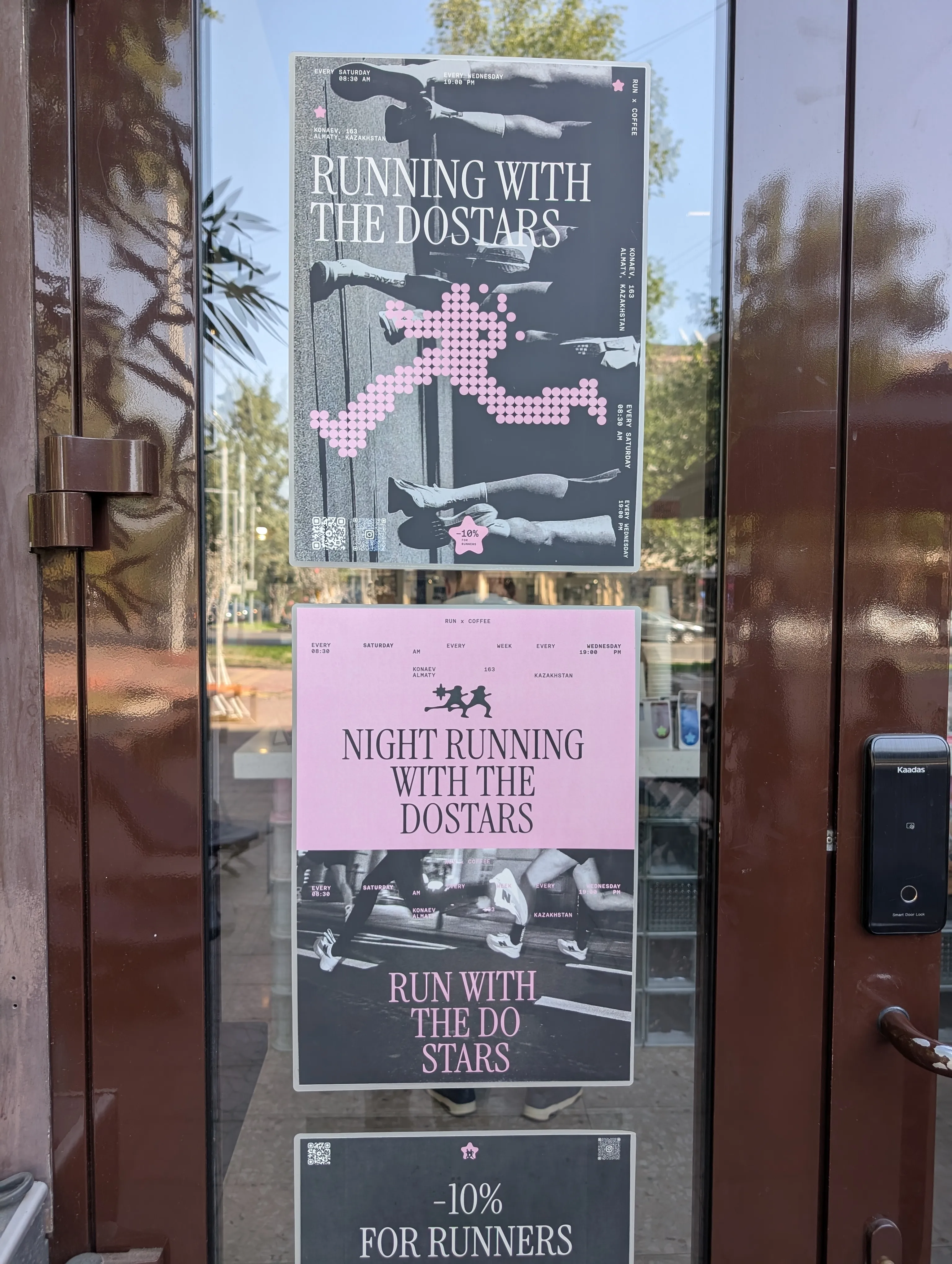 Posters on the glass door at Do.Star for its run club — 'Running with the Do.Stars' on Saturday mornings and Wednesday nights from Konaev 163, and ten per cent off for runners