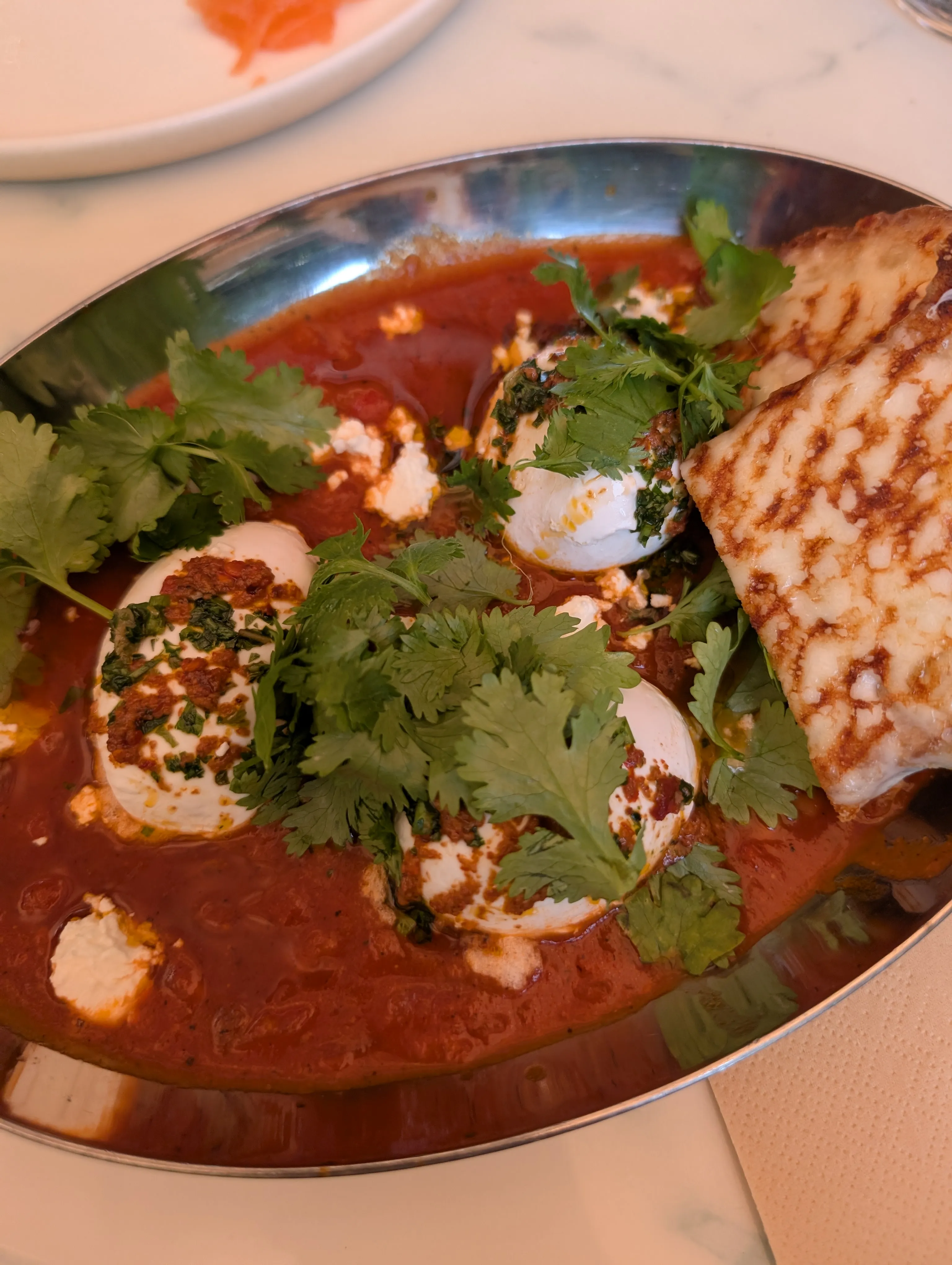 Shakshuka with feta, coriander and grilled bread at Six Bogenbay