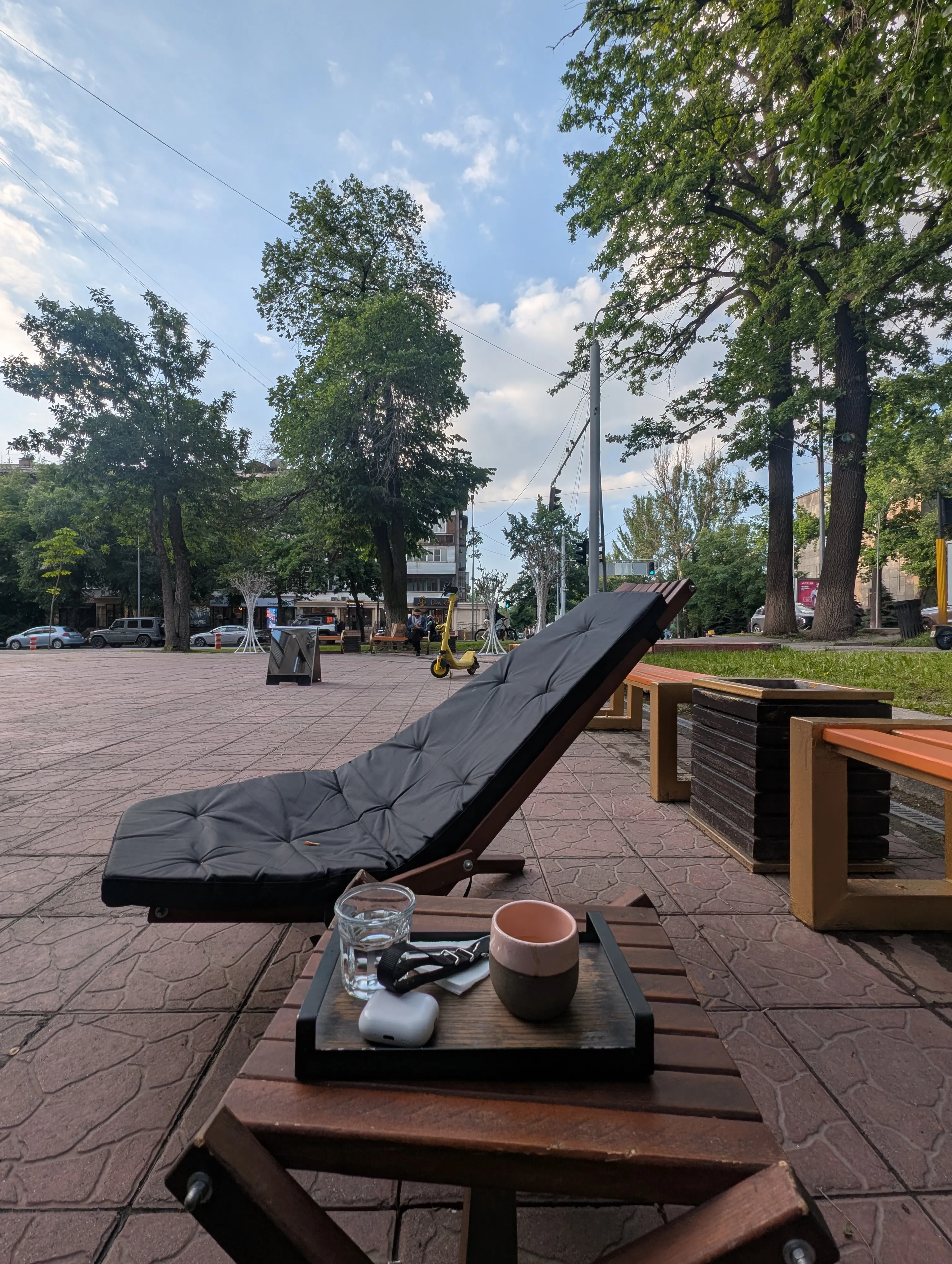 A lounger and a tray of coffee on the plaza outside Do.Star