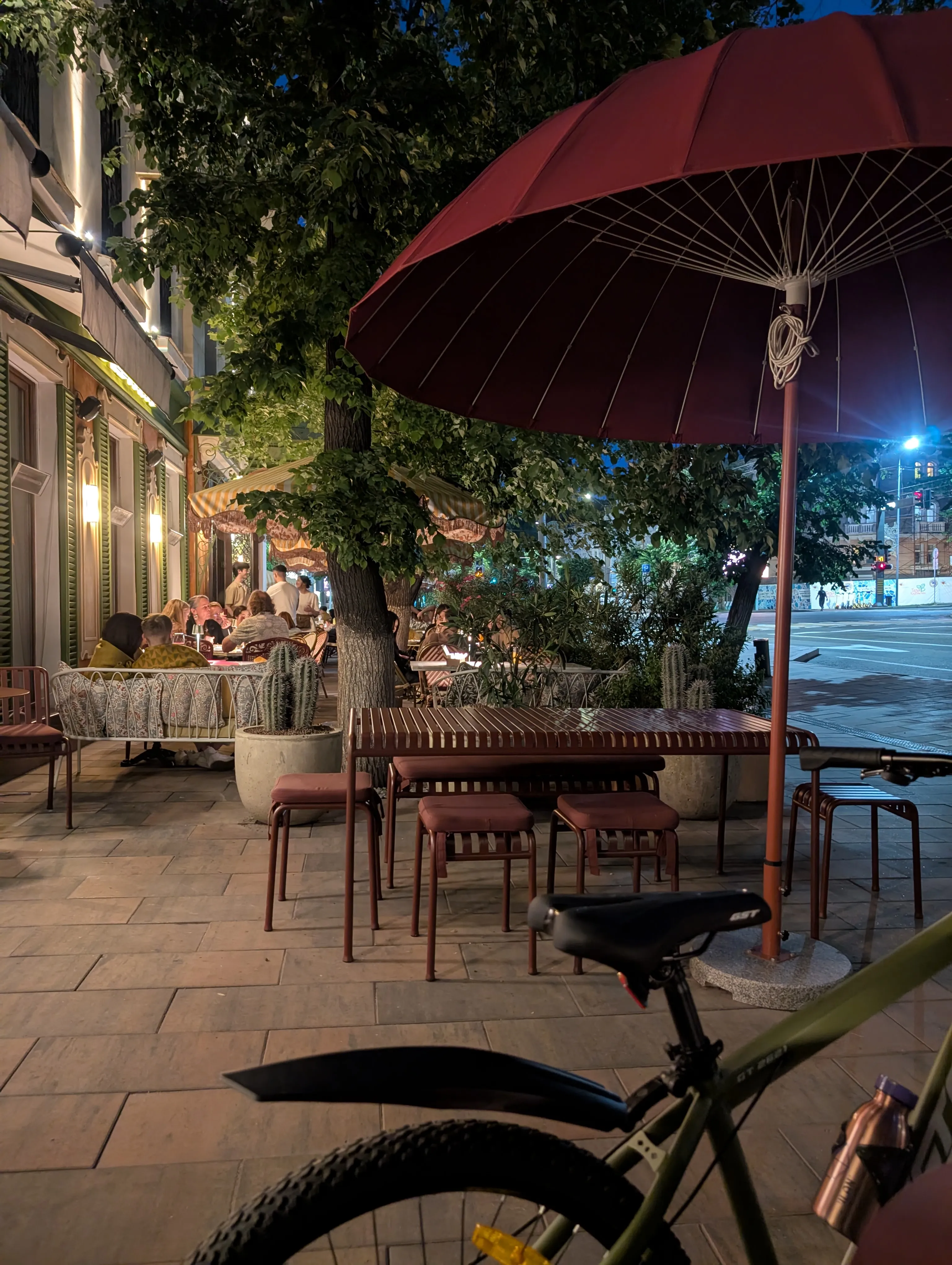 The street terrace at Julius in the evening, under a large parasol